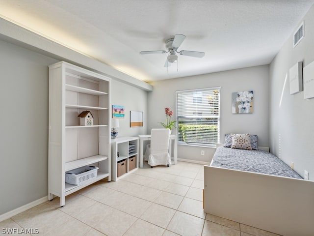 bedroom featuring ceiling fan, a textured ceiling, and light tile flooring