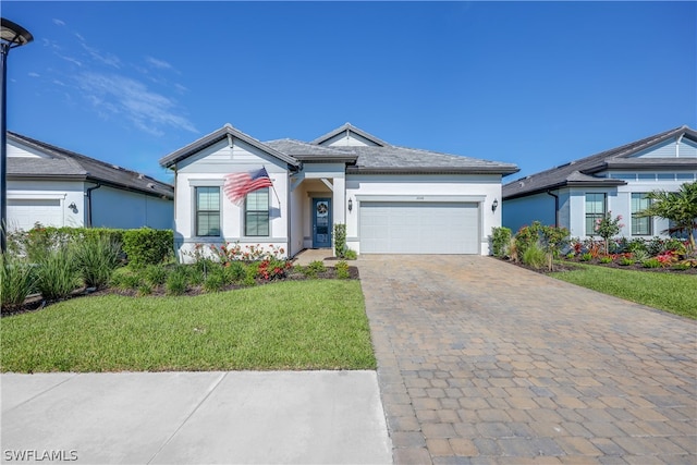 view of front facade with a garage and a front lawn