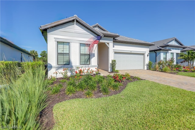 view of front of home with a front yard and a garage