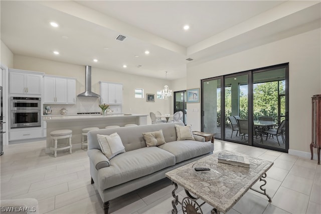 living room featuring light tile flooring and a chandelier