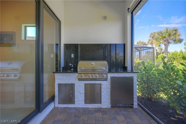 view of patio featuring area for grilling and sink