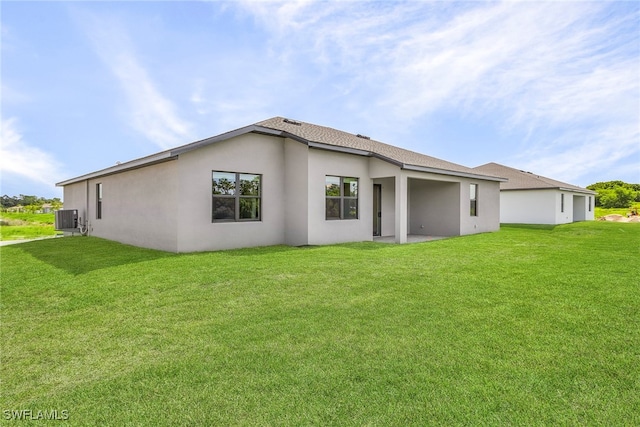 back of property with cooling unit, a patio, and a yard