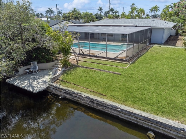 dock area with a patio area, a yard, and glass enclosure