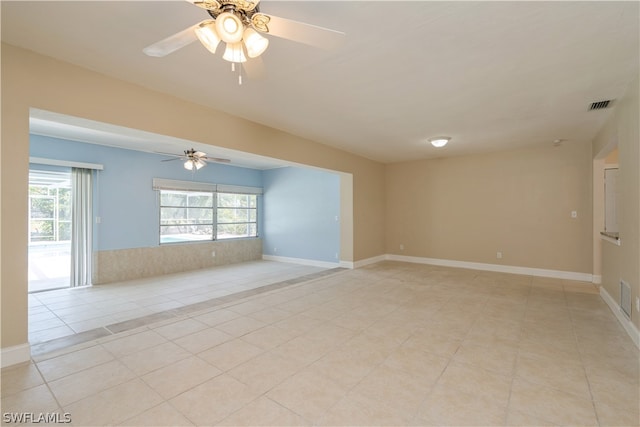 tiled empty room with ceiling fan