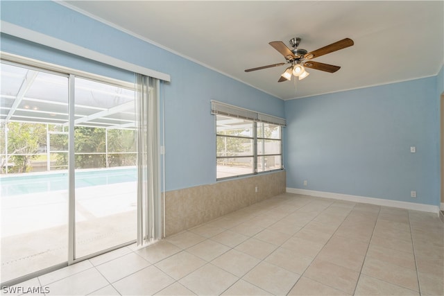 tiled spare room with ceiling fan