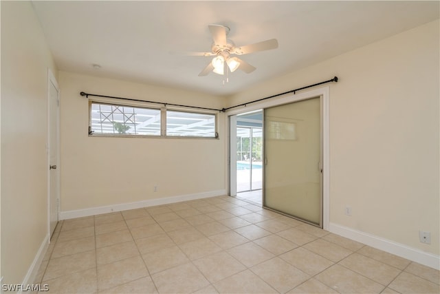 tiled empty room with ceiling fan