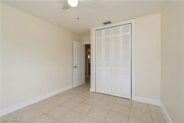 unfurnished bedroom featuring a closet, ceiling fan, and light tile flooring