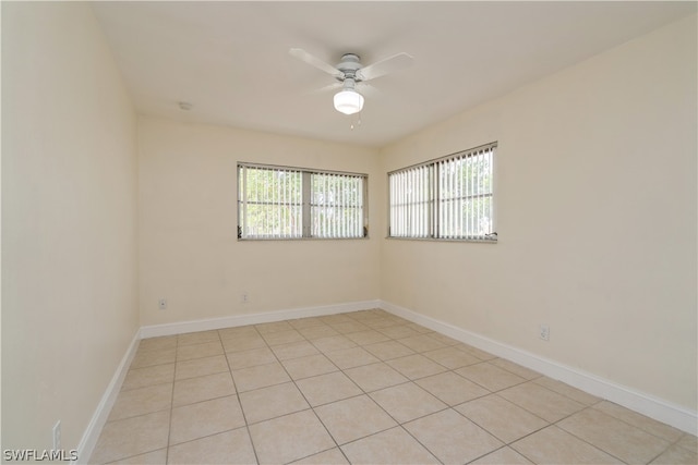 tiled empty room featuring ceiling fan