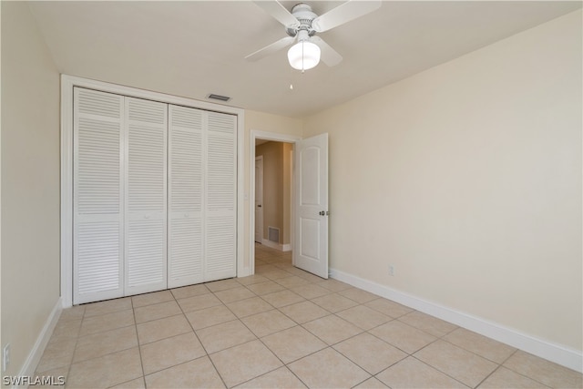 unfurnished bedroom featuring a closet, ceiling fan, and light tile floors