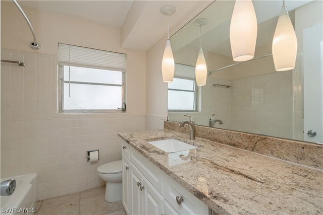 full bathroom with tile flooring, tile walls, tiled shower / bath combo, oversized vanity, and toilet