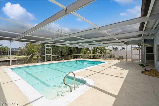 view of swimming pool with a patio and glass enclosure