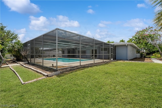 view of swimming pool featuring a lanai and a lawn