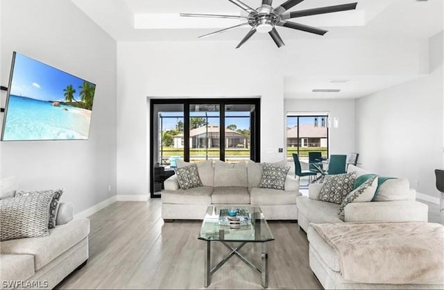 living room with ceiling fan and light wood-type flooring