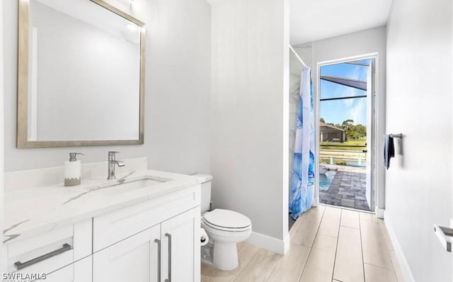 bathroom with tile floors, vanity, and toilet