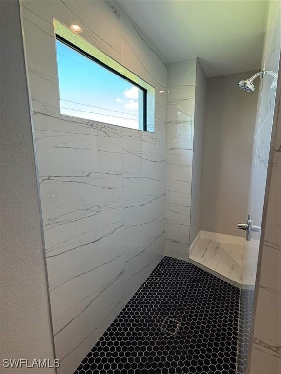 bathroom with a tile shower