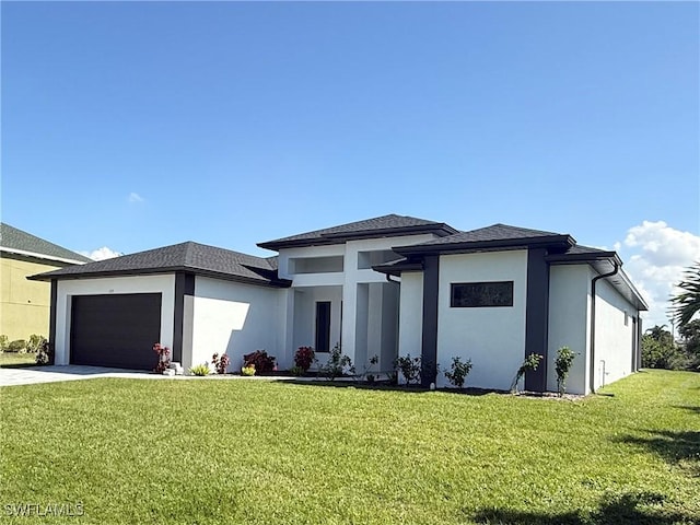 prairie-style home featuring a garage and a front lawn