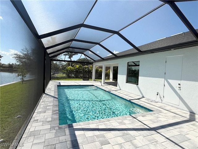 view of pool featuring glass enclosure and a patio area