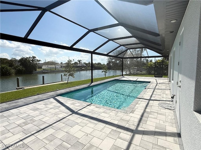 view of pool with a patio, a water view, a lawn, and glass enclosure