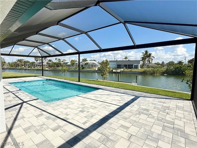 view of pool featuring a patio, a lanai, and a water view