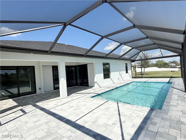 view of swimming pool featuring a patio area and a lanai