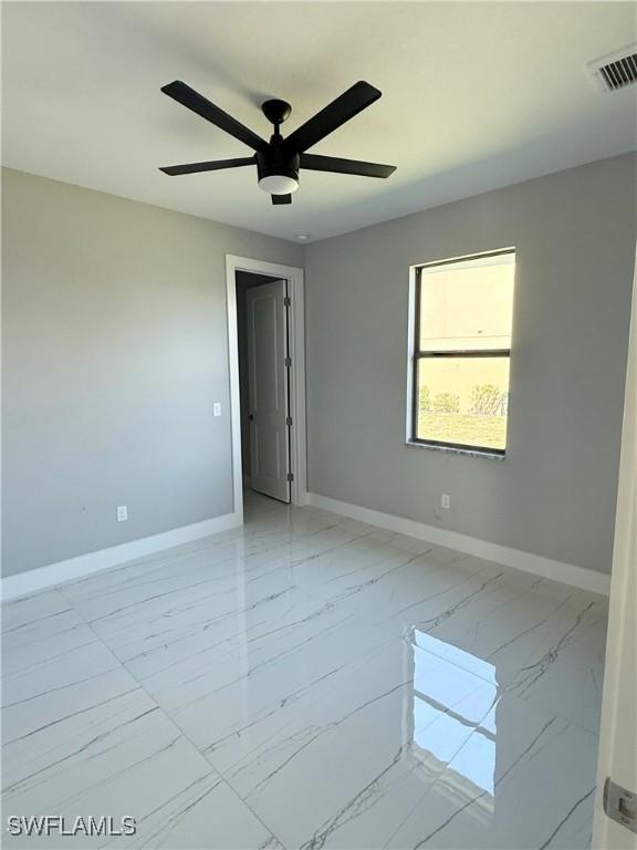 unfurnished room featuring ceiling fan