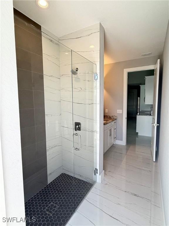 bathroom with vanity and a shower with shower door