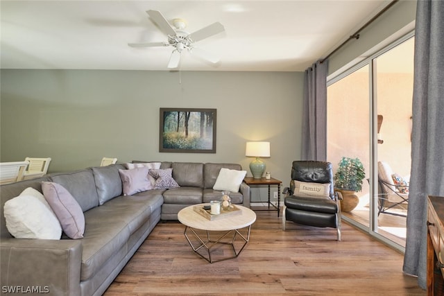 living room featuring wood-type flooring and ceiling fan