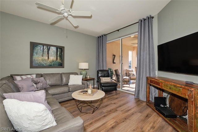 living room featuring wood-type flooring and ceiling fan