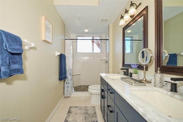 bathroom featuring tile flooring, toilet, tiled shower, and double sink vanity