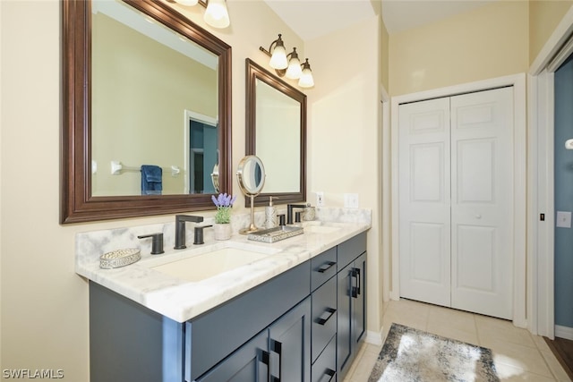 bathroom with oversized vanity, tile floors, and dual sinks