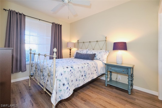 bedroom featuring ceiling fan and dark wood-type flooring