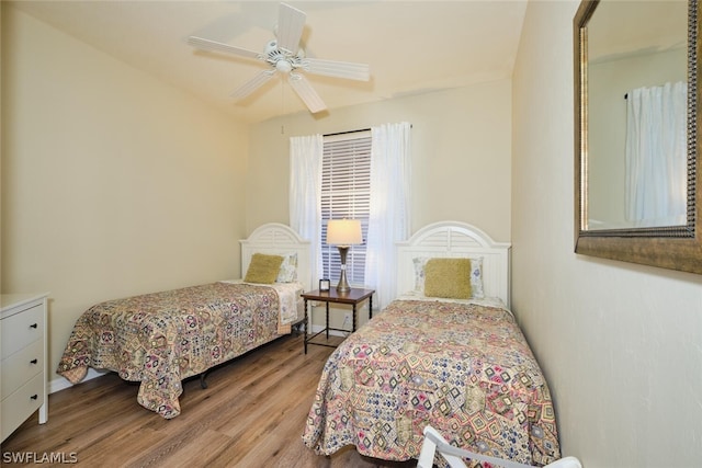 bedroom with ceiling fan and hardwood / wood-style flooring