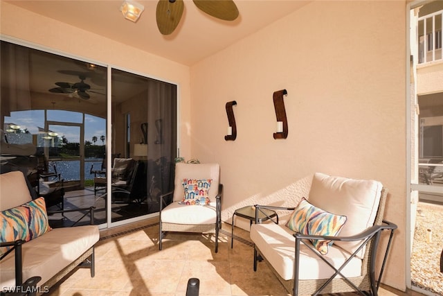 interior space featuring ceiling fan and a water view