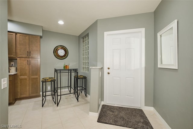 doorway to outside with light tile flooring