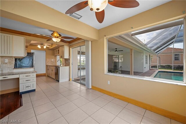 kitchen featuring dishwasher, backsplash, light tile patterned floors, fridge, and white cabinetry