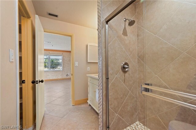 bathroom featuring tile patterned floors and a shower with door