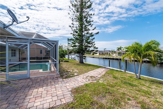 view of yard featuring glass enclosure and a water view