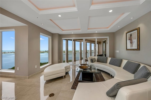 living room featuring a water view, ornamental molding, and coffered ceiling