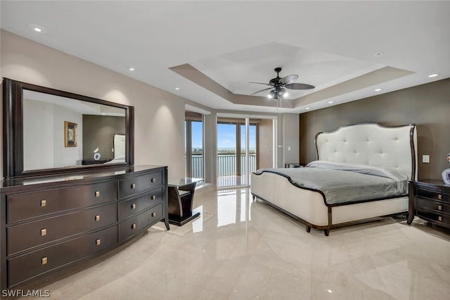 bedroom with a tray ceiling, access to outside, and ceiling fan