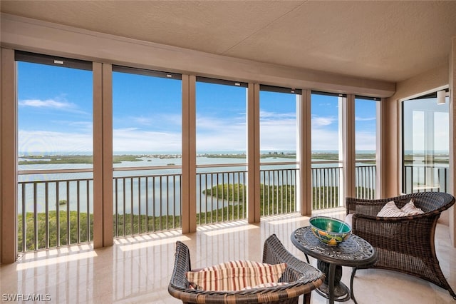 sunroom / solarium with a water view