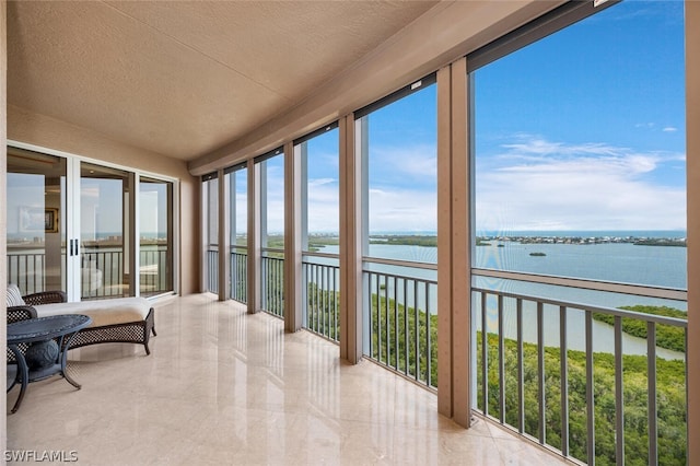 sunroom / solarium with a water view