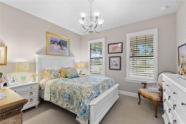 carpeted bedroom featuring an inviting chandelier