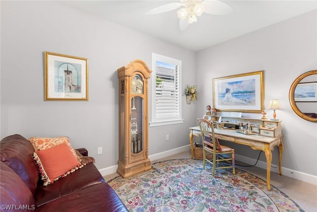 office space with ceiling fan and light carpet