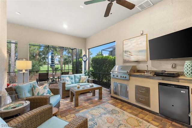 living room with ceiling fan and sink