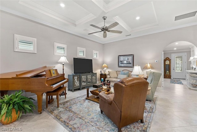 living room with ceiling fan, coffered ceiling, beamed ceiling, light tile patterned floors, and ornamental molding