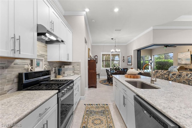 kitchen with appliances with stainless steel finishes, hanging light fixtures, crown molding, sink, and white cabinetry