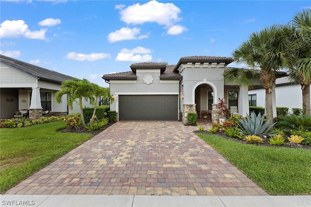 mediterranean / spanish-style house featuring a front lawn and a garage