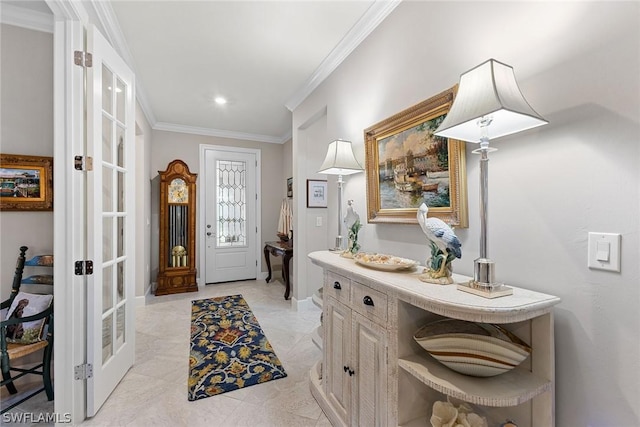 entrance foyer featuring crown molding and french doors