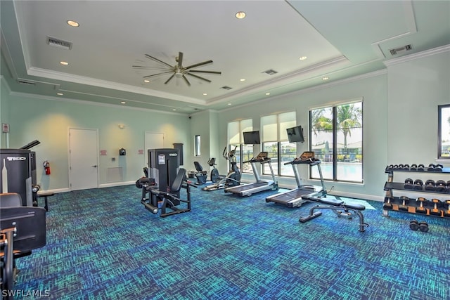 gym featuring crown molding, carpet floors, and a tray ceiling