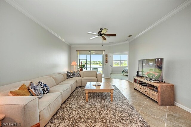 tiled living room with ceiling fan and ornamental molding